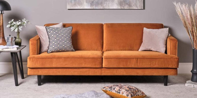 How can you make cushions look good on a colourful sofa?