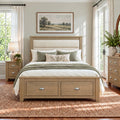 Wooden framed bedstead with two drawers with cup handles for storage.