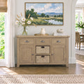 A light natural wood sideboard cabinet with three drawers, two cabinet doors, and two woven storage baskets, styled in a bright, modern living room setting.