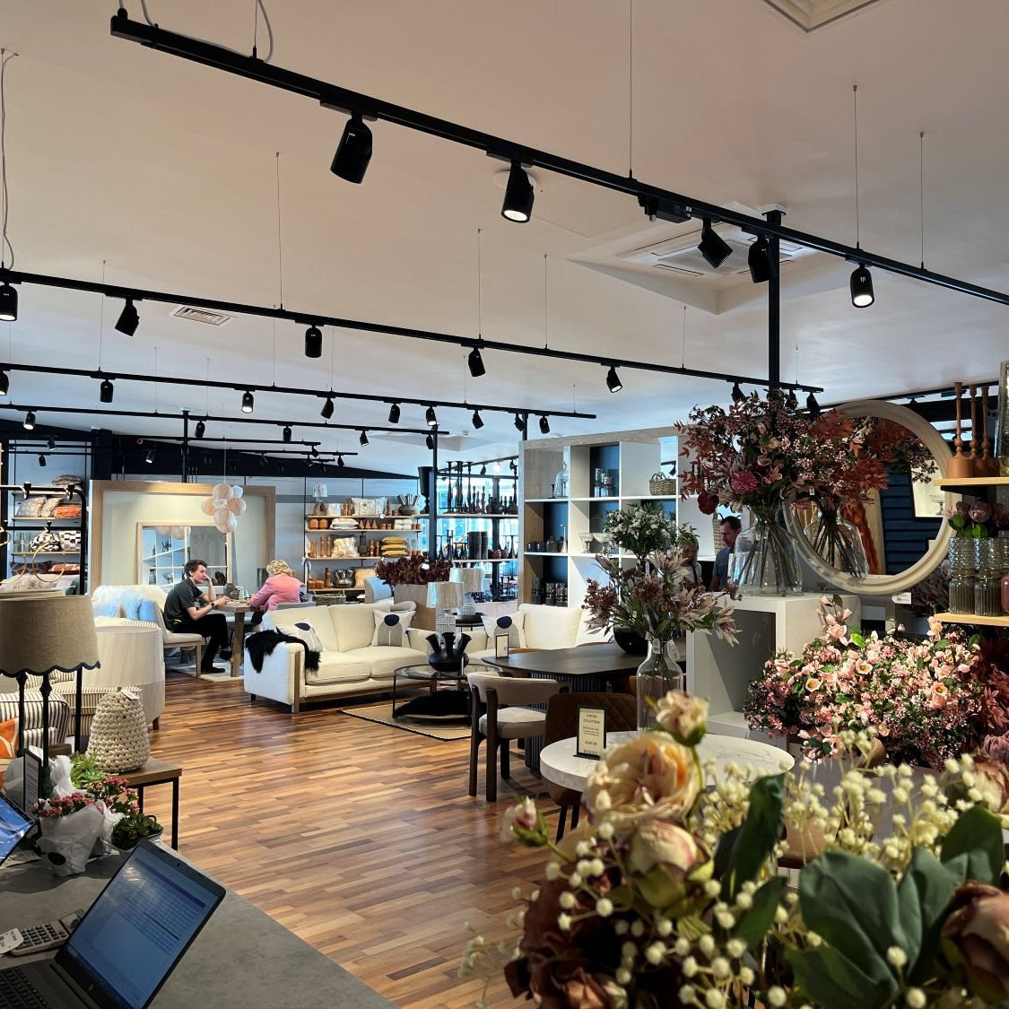 Modern interior design with floral arrangements, furniture, and decor elements.
