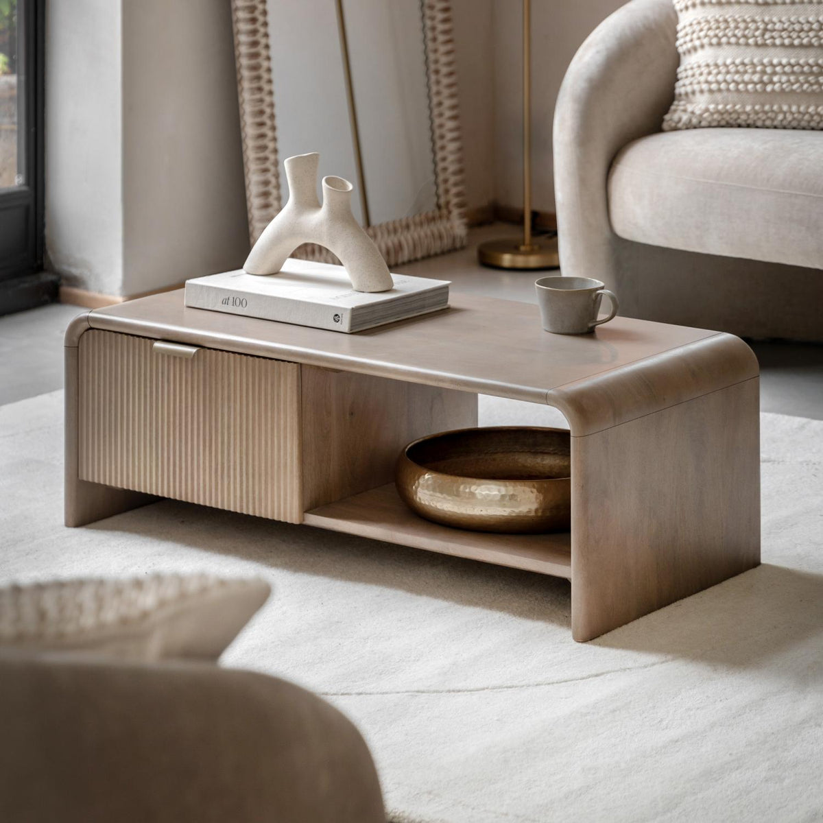 Coffee table with decorative items in a living room setting