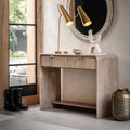 Modern interior with a wooden console table, decorative lamp, and mirror.