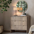 Wooden dresser with lamp and mirror in a room setting