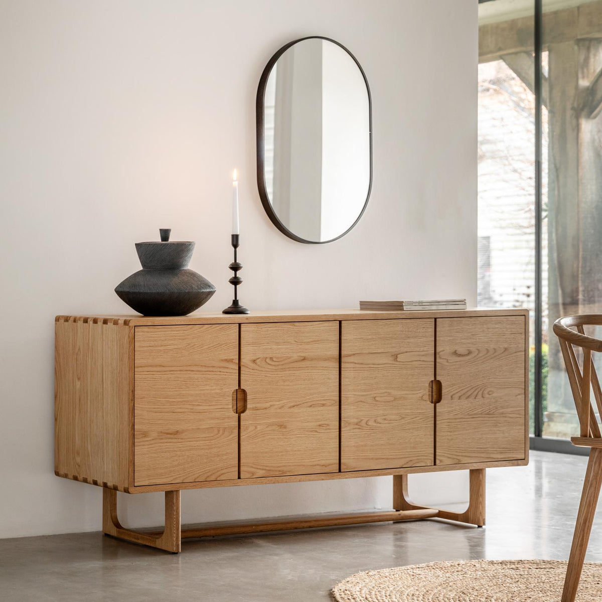 Wooden sideboard with decorative items in a modern living room.