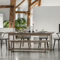 Dining area with wooden table and chairs in a modern interior setting.
