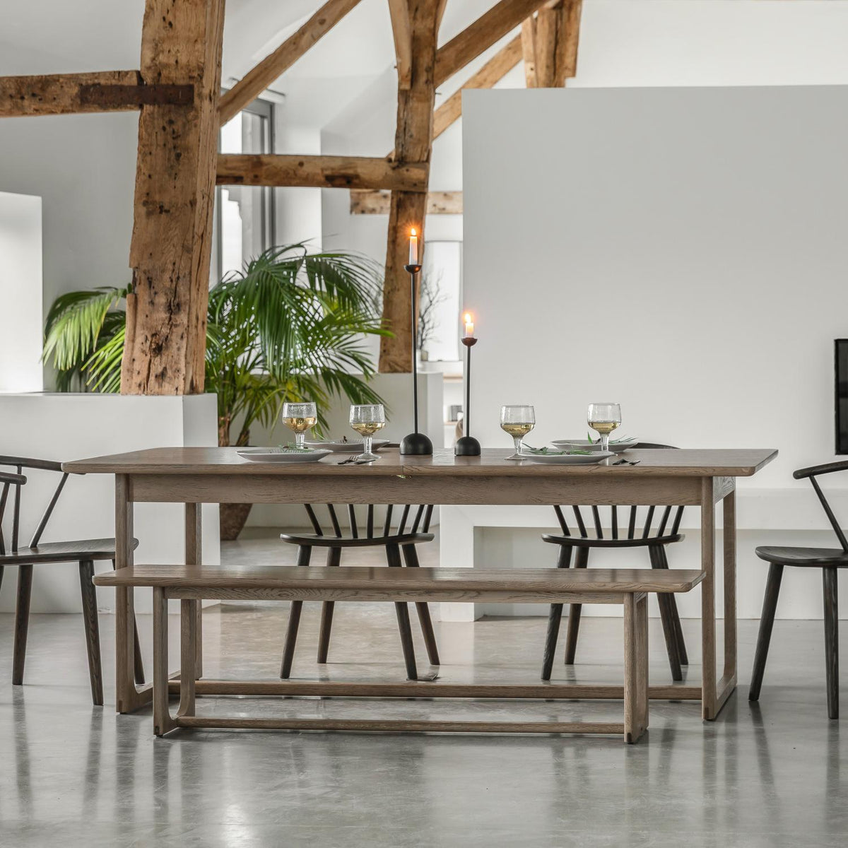 Dining area with wooden table and chairs in a modern interior setting.