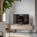 Modern living room with a television on a wooden stand, surrounded by minimal decor.