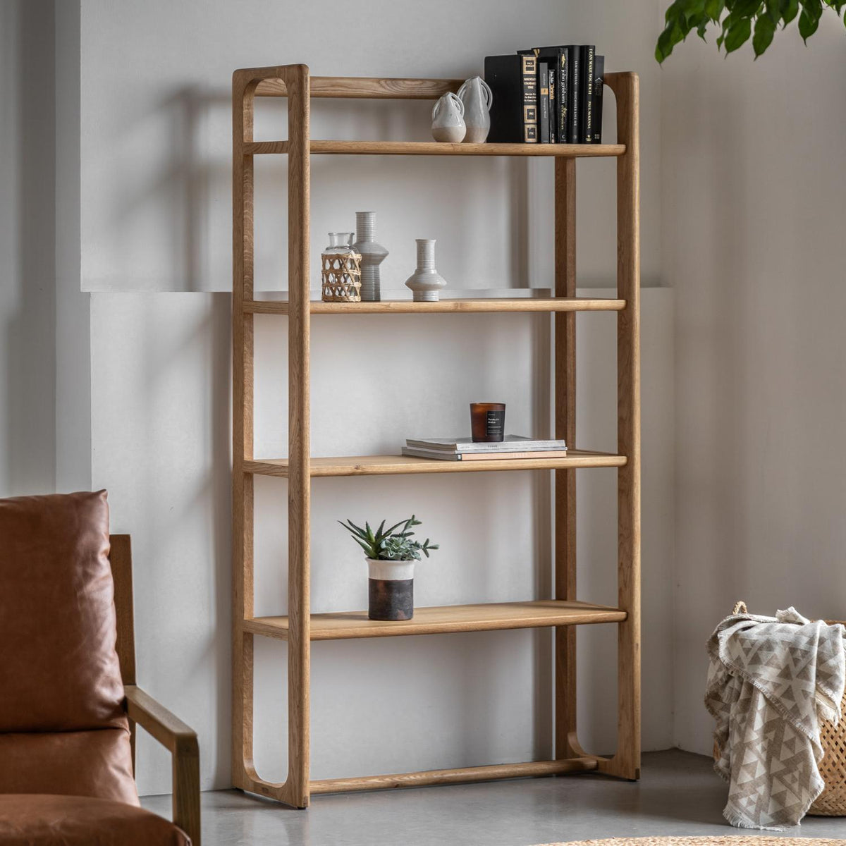 Wooden bookshelf with decorative items in a room setting