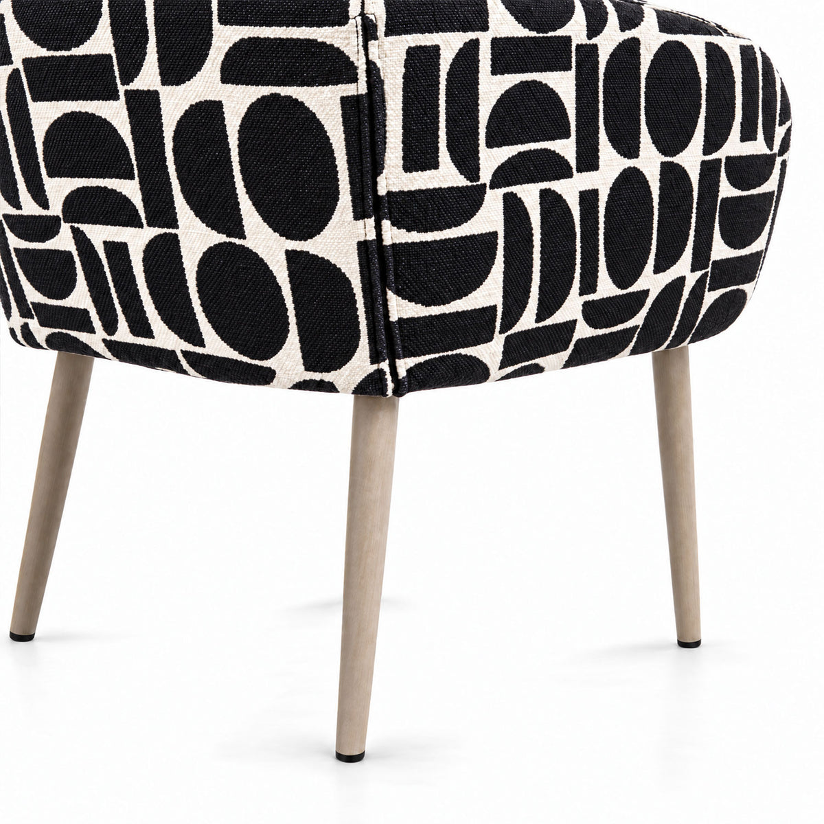 Rear view of the Sloane dining chair in black geometric pattern fabric with tapered wooden legs