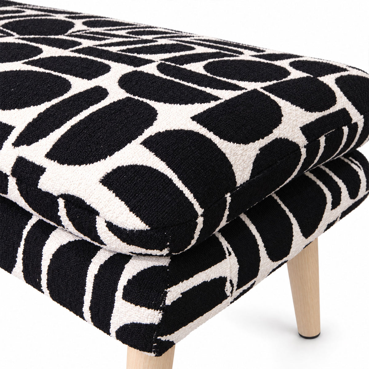 Close-up of the layered cushion on the Sloane flat bench in black geometric pattern fabric