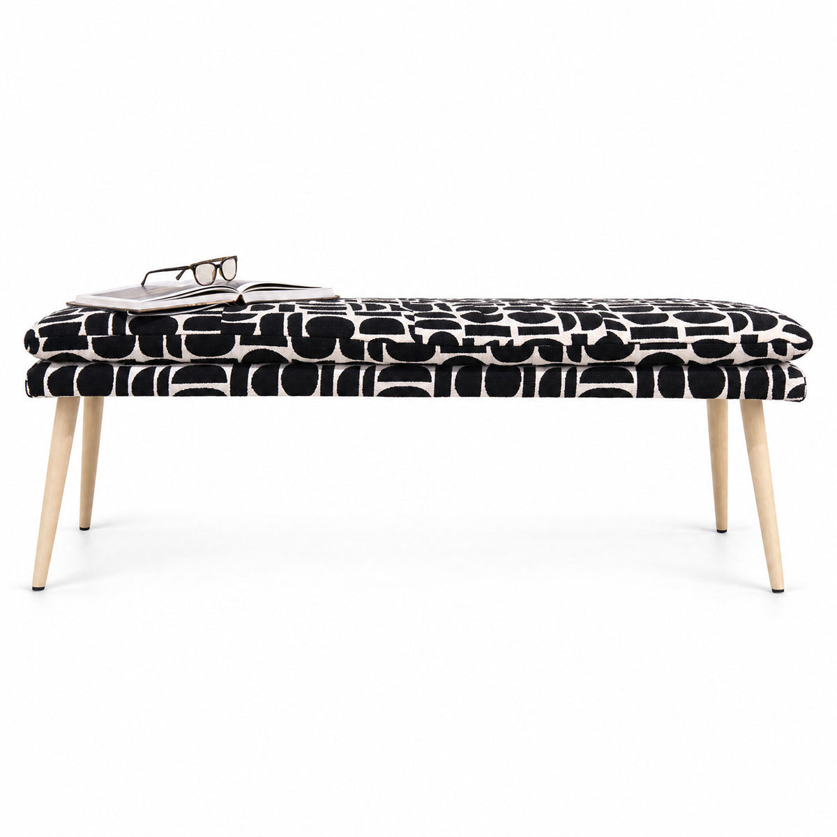 Sloane 140cm flat bench in black geometric pattern fabric with tapered natural wooden legs, angled view