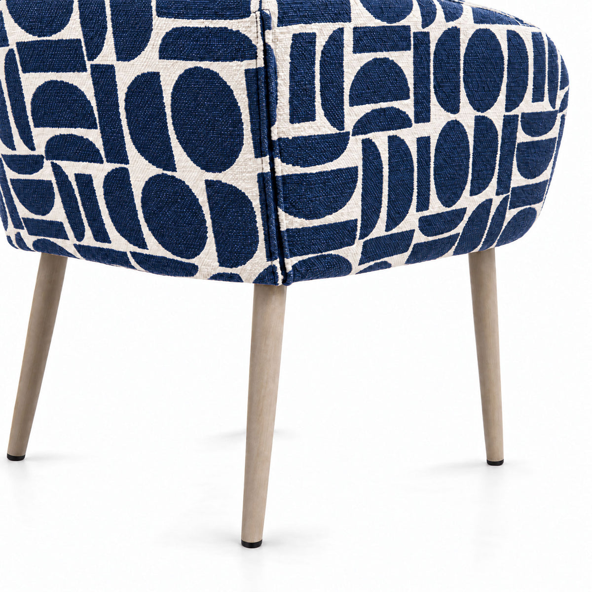 Rear view of the Sloane dining chair in blue geometric pattern fabric with tapered wooden legs