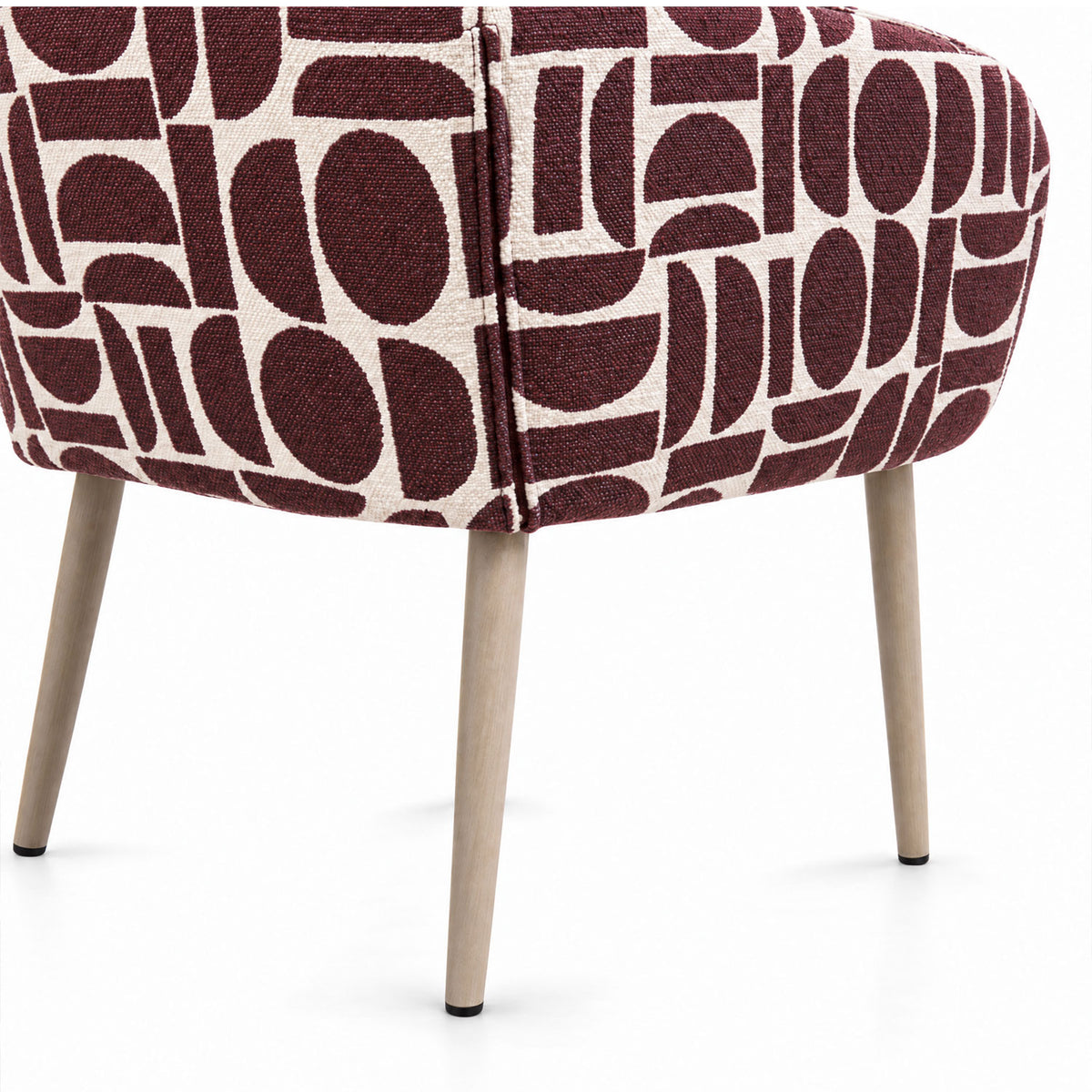 Rear view of the Sloane dining chair in plum geometric pattern fabric with tapered wooden legs