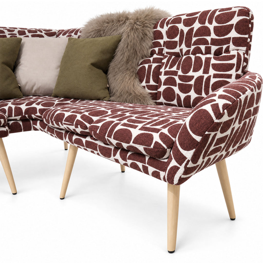 Close-up of the Sloane corner bench end seat and curved backrest in plum geometric pattern fabric