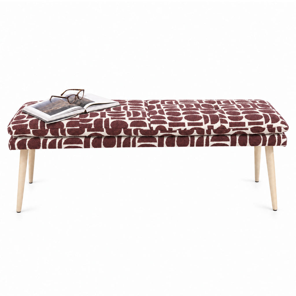 Sloane 140cm flat bench in plum geometric pattern fabric with tapered natural wooden legs, angled view