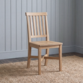 A light natural wood dining chair with a slatted backrest, shown standing on a woven jute rug against a gray paneled wall.