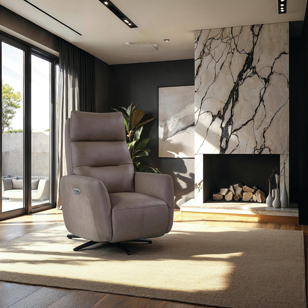 A modern taupe upholstered recliner chair with a black swivel base, placed in a stylish contemporary living room with a marble fireplace, large windows, and a beige rug.