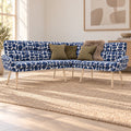 Sloane L-shaped corner bench in blue and cream geometric pattern boucle style fabric with green cushions and a faux fur throw