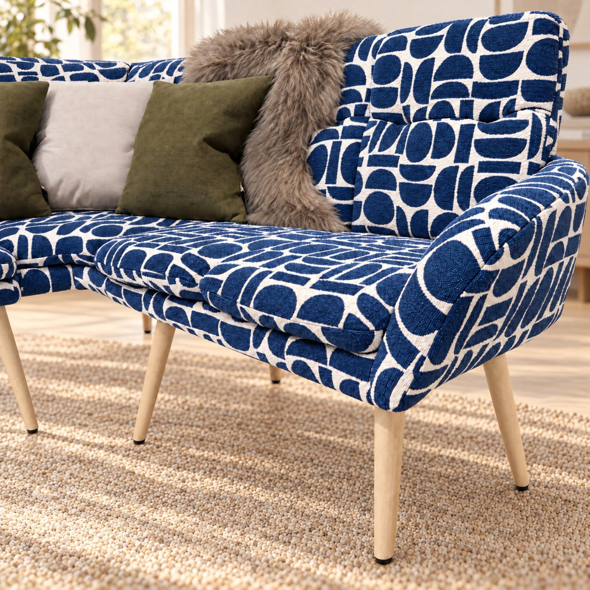 Seat cushion and arm of the Sloane corner bench in blue geometric pattern fabric on beech-wrapped metal legs