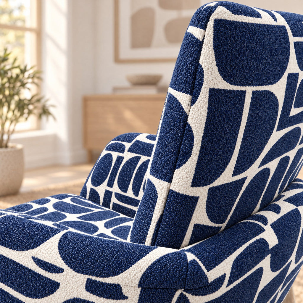 Close-up of the curved back and arm of the Sloane dining chair in blue geometric pattern boucle style fabric