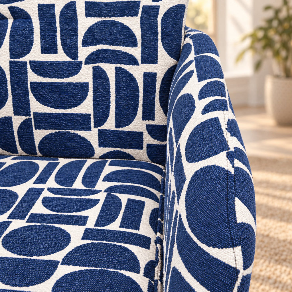 Detail of the textured blue and cream geometric pattern boucle style fabric on the Sloane dining chair seat and arm