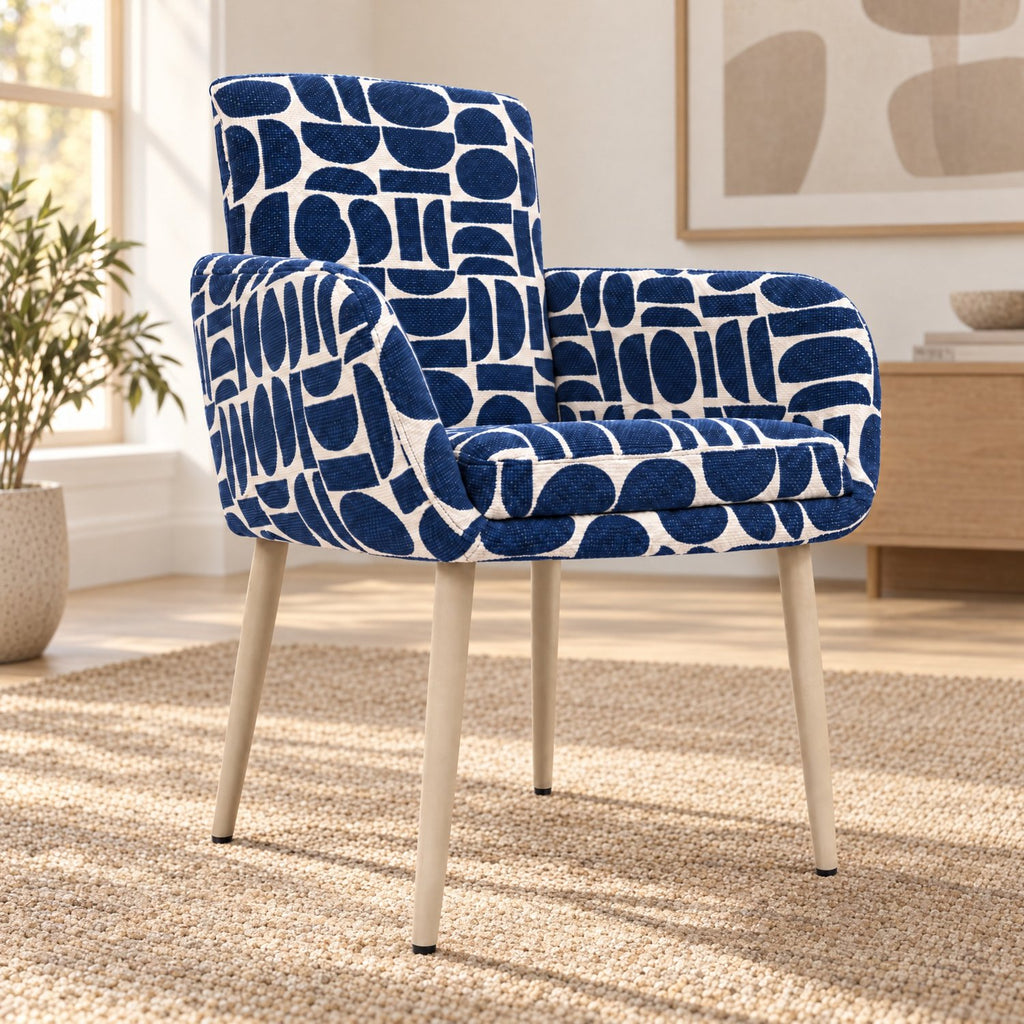 Sloane dining chair with arms in blue and cream geometric pattern boucle style fabric on beech-wrapped metal legs in a bright living room