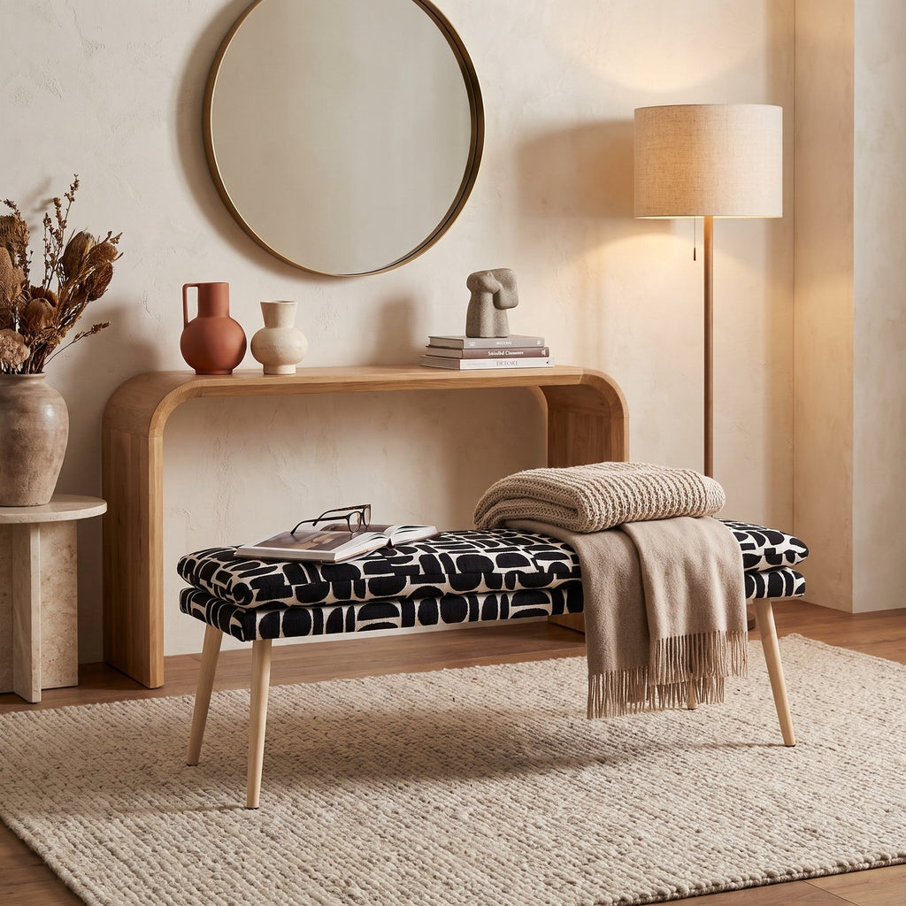 Sloane 140cm flat bench in black geometric pattern boucle style fabric in a hallway beneath a console table and round mirror