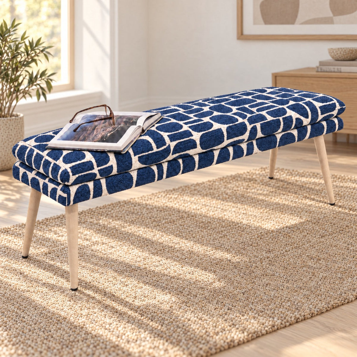 Sloane 140cm flat bench in blue and cream geometric pattern boucle style fabric on a jute rug in a sunlit room